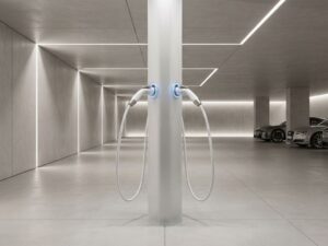Elektrische laadpaal met twee witte kabels in moderne parkeergarage met blauwe accentverlichting