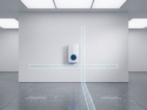 Moderne EV-laadpaal gemonteerd op witte muur met meetlinten die minimale afstandszones tonen op betonnen vloer