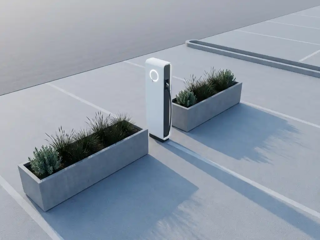 Moderne elektrische laadpaal met wit behuizing in zakelijke parkeerplaats, omringd door geometrische betonnen plantenbakken